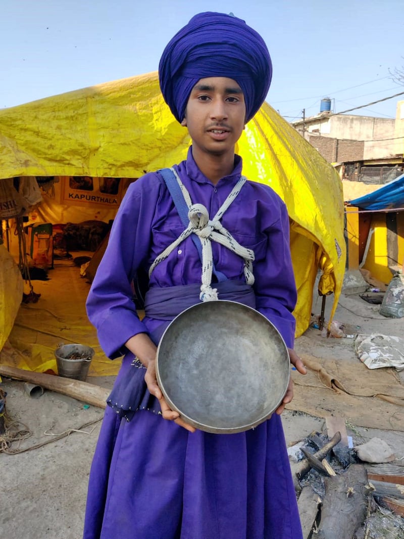 Sartaj Singh, 15, shows the traditional iron bowl that Nihangs still use to eat meals strictly prepared by community cooks. Taniya Dutta for The National