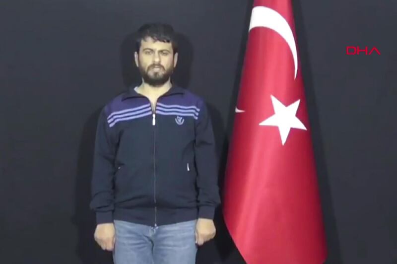 A grab taken from a video released on September 12, 2018 by Demiroren News Agency shows Turkish citizen Yusuf Nazik, the alleged chief suspect in a 2013 bombing on the border with its conflict-torn neighbour that left over 50 dead, delivering a speech after he was captured by the Turkish secret service. - Turkish citizen Yusuf Nazik, who is accused of planning the May 2013 Reyhanli bombing, was apprehended in an operation by the National Intelligence Organisation (MIT) in the Syrian city of Latakia and brought to Turkey. Nazik, dressed in a tracksuit top and jeans and standing by a Turkish flag, giving what it described as a "confession", saying he was behind the attack and it had been ordered by the Syrian regime. (Photo by - / Demiroren News Agency / AFP) / - Turkey OUT / RESTRICTED TO EDITORIAL USE - MANDATORY CREDIT "AFP PHOTO / DEMIROREN NEWS AGENCY" - NO MARKETING NO ADVERTISING CAMPAIGNS - DISTRIBUTED AS A SERVICE TO CLIENTS