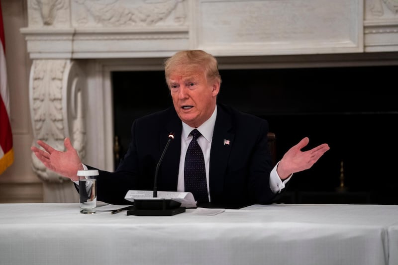 epa08431005 US President Donald J. Trump reveals that he is taking Hydroxychloroquine prophylaxis against COVID-19 as he participates in a roundtable with Restaurant Executives and Industry Leaders in the State Dining Room, in the White House, Washington, DC, USA, 18 May 2020.  EPA/Doug Mills / POOL