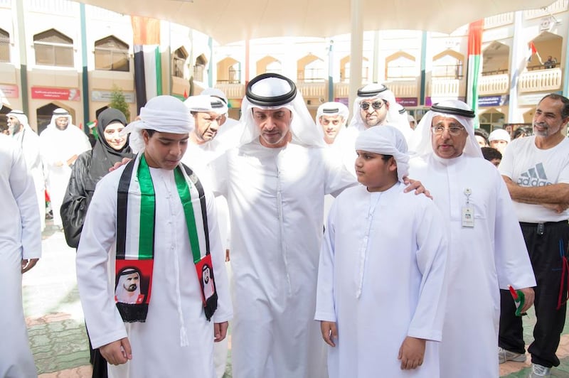 Sheikh Hazza bin Zayed, Vice Chairman of the Abu Dhabi Executive Council, centre, speaks with Zayed Al Thani School students on Flag Day. Mohamed Al Suwaidi / Crown Prince Court — Abu Dhabi