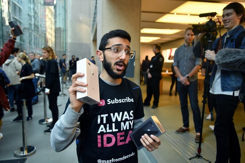 Mazen Kourouche shows off the new Apple products at the Apple Store in Sydney. Joel Carrett / EPA