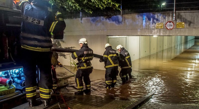 Firefighters pump water from a flooded underground car park in Sindelfingen.  Dettenmeyer / EPA