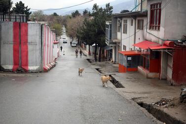 People walk on a mostly empty street during a lockdown aimed at curbing the spread of the coronavirus in Kabul. AP