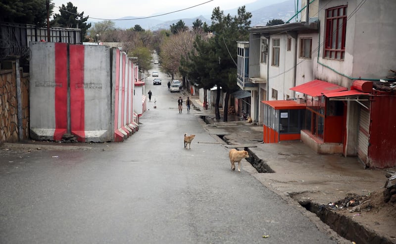 People walk on a mostly empty street during a lockdown aimed at curbing the spread of the coronavirus in Kabul, Afghanistan, Tuesday, March 31, 2020. The Afghan government last Friday ordered a three-week lock-down for Kabul to stem the spread of the virus. (AP Photo/Rahmat Gul)