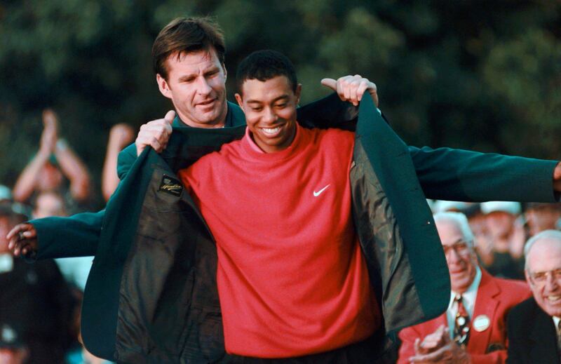 Tiger Woods receives his Green Jacket from Nick Faldo, left, after winning the 1997 US Masters. AP Photo