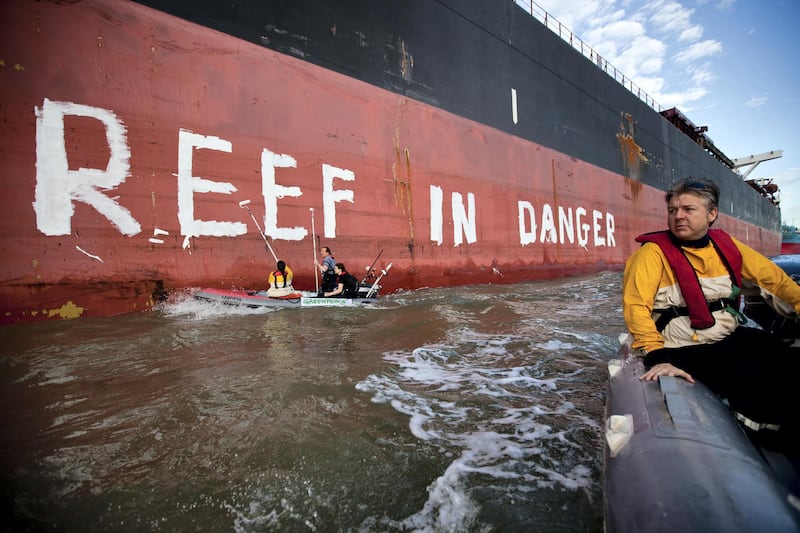 GLADSTONE, AUSTRALIA - MARCH 7: In this handout photo provided by Greenpeace, Activists paint the message "Reef in Danger" on the side of coal ship Chou San on March 7, 2012 in Gladstone, Australia. A delegation from UNESCO is arriving in Gladstone today to assess threats to the Great Barrier Reef, both existing projects and the expected increase in transport through the World Heritage area following a planned coal mine expansion. (Photo by Greenpeace via Getty Images)