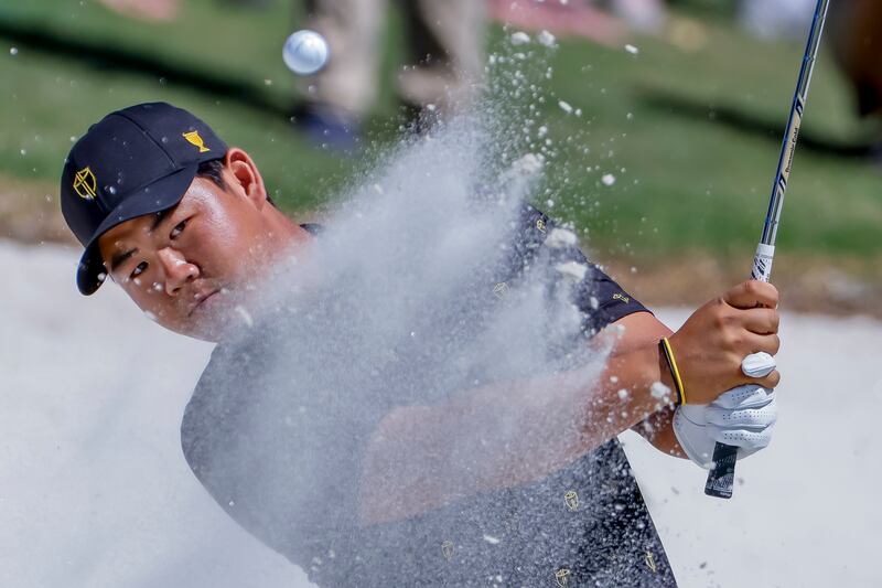 Golfer Tom Kim of South Korea hits from a bunker on the first hole during four-ball matches of the 2022 Presidents Cup tournament, at the Quail Hollow Club, in Charlotte, North Carolina, US. EPA