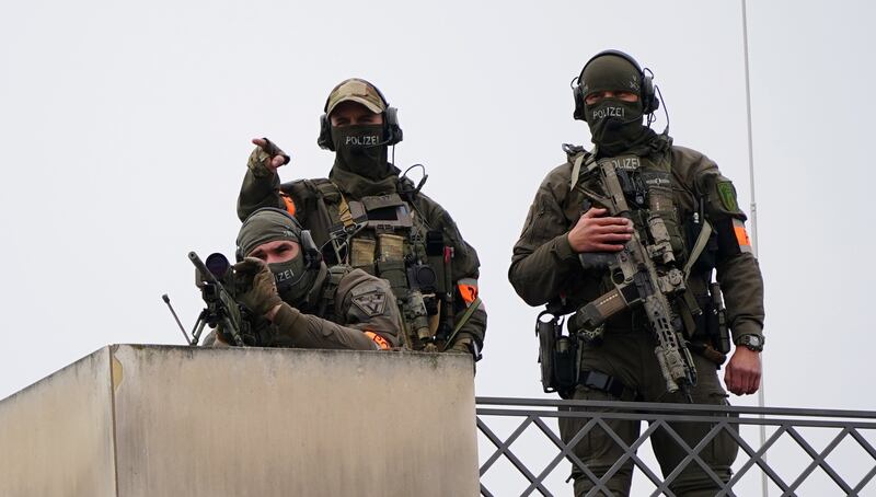 Police officers keep watch during the royal visit to Berlin. EPA