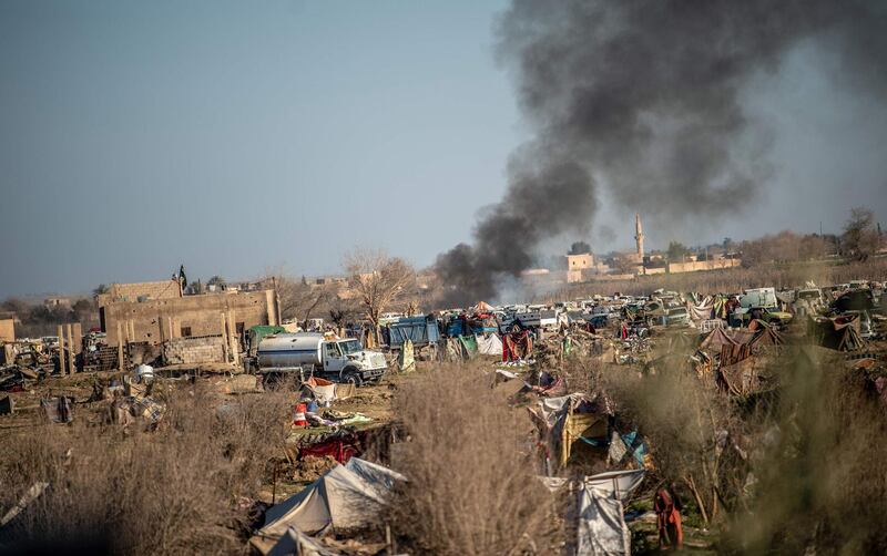 Smoke rises from a makeshift camp for ISIS members and their families in the town of Baghouz, in the eastern Syrian province of Deir Ezzor.  AFP