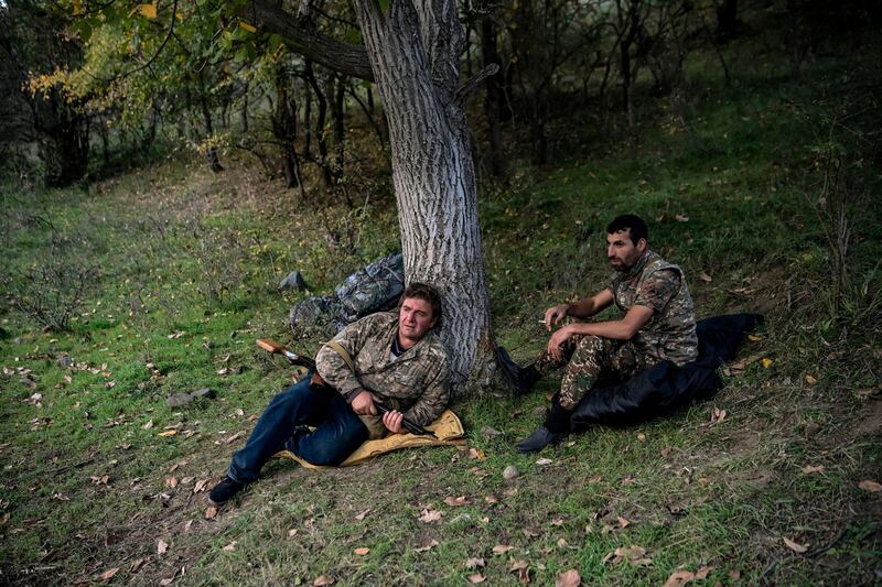 Volunteer fighters stand in a village south-east of Stepanakert during the ongoing fighting between Armenian and Azerbaijani forces. AFP