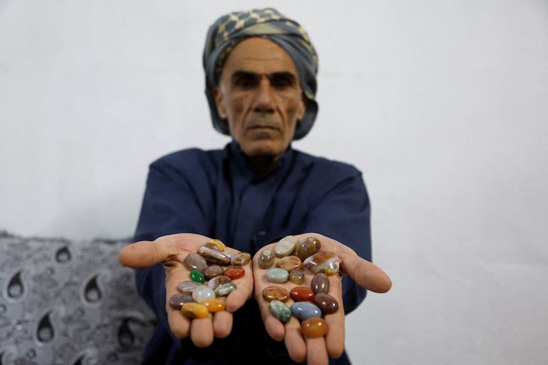 Former Iraqi army officer Hashim Suaan displays gemstones collected near the Tigris River in Mosul, Iraq. All photos: Reuters  