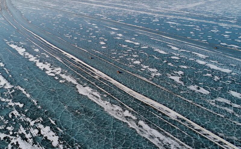 Cars drive along a five-kilometre-long road, which is supervised by regional traffic services to connect the banks of the ice-covered Yenisei River during winter season, south of Krasnoyarsk, Russia. Reuters