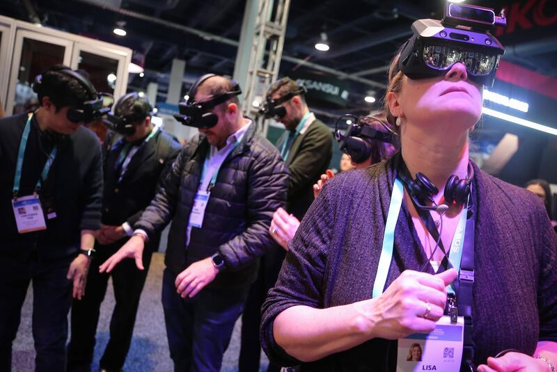 LAS VEGAS, NEVADA - JANUARY 07: Attendees try out Realmax augmented reality (AR) glasses at the Realmax booth at CES 2020 at the Las Vegas Convention Center on January 7, 2020 in Las Vegas, Nevada. CES, the world's largest annual consumer technology trade show, runs through January 10 and features about 4,500 exhibitors showing off their latest products and services to more than 170,000 attendees.   Mario Tama/Getty Images/AFP
== FOR NEWSPAPERS, INTERNET, TELCOS & TELEVISION USE ONLY ==
