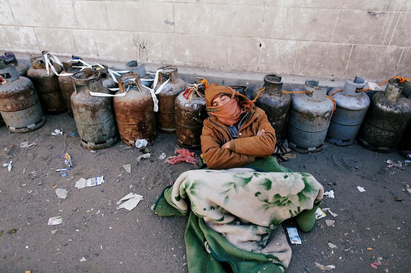 A man sleeps next to a queue of cooking gas cylinders outside a gas filling station amid a scarcity in cooking gas supplies in Sanaa, Yemen. Khaled Abdullah / Reuters