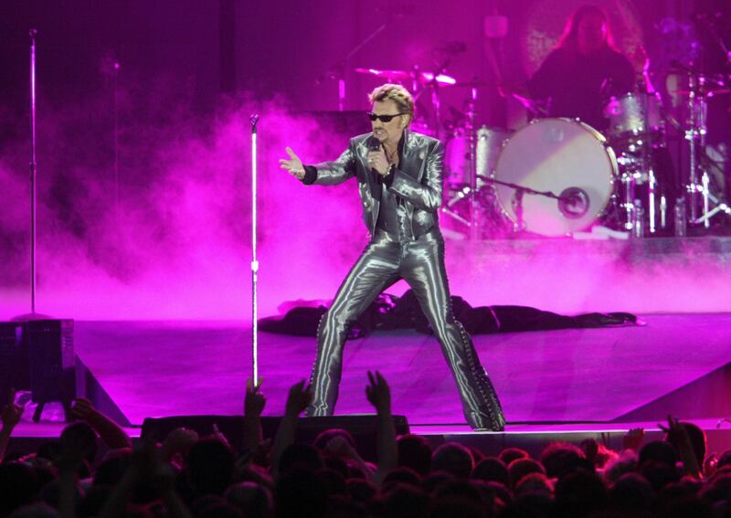 (FILES) This file photo taken on June 11, 2003 shows French singer Johnny Hallyday performing at the Parc des Princes stadium in Paris.     
France's best-known rock star Johnny Hallyday has died aged 74 after a battle with lung cancer, his wife Laeticia told AFP on December 6, 2017. / AFP PHOTO / FRANCOIS XAVIER MARIT