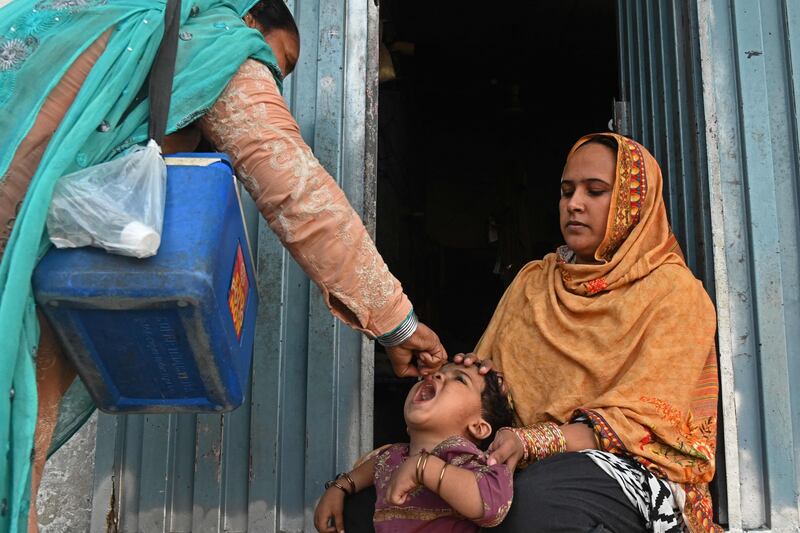 A health worker administers the live polio vaccine to a child during a vaccination campaign in Lahore. AFP
