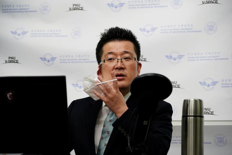 Park Hyun, a professor at Pusan National University Park Hyun, who used to be a coronavirus patient, takes off his mask as he gives an online lecture at Pusan National University in Busan. Reuters