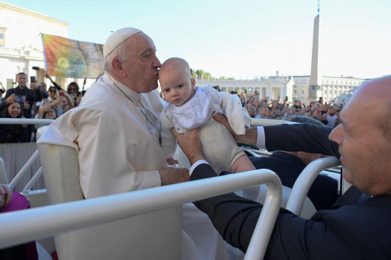 Pope Francis kisses a child during a general audience at the Vatican.  Reuters