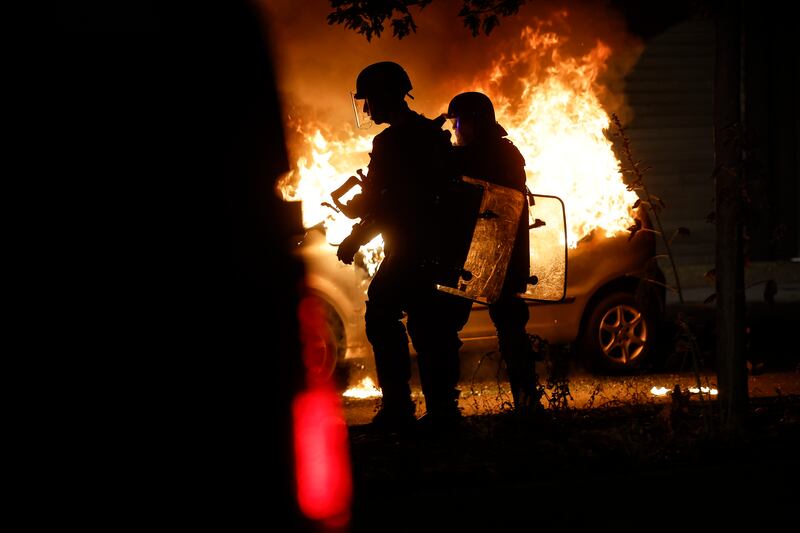 A burning car in the La Meinau district of Strasbourg, eastern France.  AP