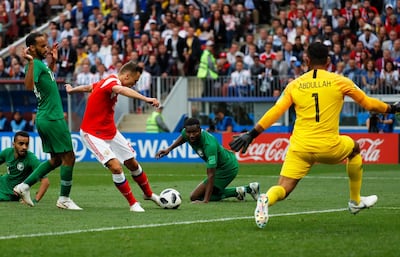 epa06807438 Denis Cheryshev (C-L) of Russia scores the 2-0 lead against Saudi Arabia's goalkeeper Abdullah Almuaiouf (R) during the FIFA World Cup 2018 group A preliminary round soccer match between Russia and Saudi Arabia in Moscow, Russia, 14 June 2018.

(RESTRICTIONS APPLY: Editorial Use Only, not used in association with any commercial entity - Images must not be used in any form of alert service or push service of any kind including via mobile alert services, downloads to mobile devices or MMS messaging - Images must appear as still images and must not emulate match action video footage - No alteration is made to, and no text or image is superimposed over, any published image which: (a) intentionally obscures or removes a sponsor identification image; or (b) adds or overlays the commercial identification of any third party which is not officially associated with the FIFA World Cup)  EPA/YURI KOCHETKOV   EDITORIAL USE ONLY