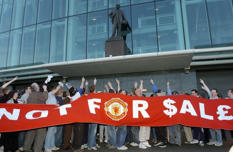 Fans outside Old Trafford show their feelings towards Malcolm Glazer's bid to purchase Manchester United in May 2005. All photos: Getty Images