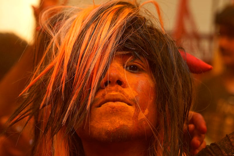 A reveller smeared with coloured powder, in Hyderabad. AP