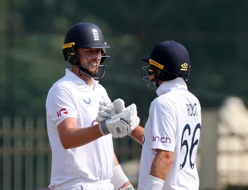 England's Ollie Robinson celebrates with Joe Root after reaching his half century. Reuters