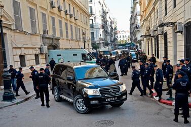 Members of Algerian security stand by upon the arrival of security vehicles transporting the accused to Sidi M’hamed court in the capital Algiers ahead of the opening of a corruption trial of former political and business figures, which has now been postponed. AFP