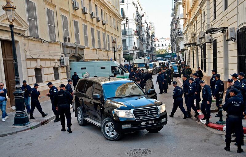 Members of Algerian security stand by upon the arrival of security vehicles transporting the accused to Sidi M’hamed court in the capital Algiers on December 2, 2019, ahead of the opening of a corruption trial of former political and business figures. A Corruption trial opens today in the Algerian capital against ex-political leaders and businessmen, including two former prime ministers, three former ministers, an ex-wali, four businessmen deemed among the country's richest, and many officials from the central and regional administrations. / AFP / RYAD KRAMDI                        
