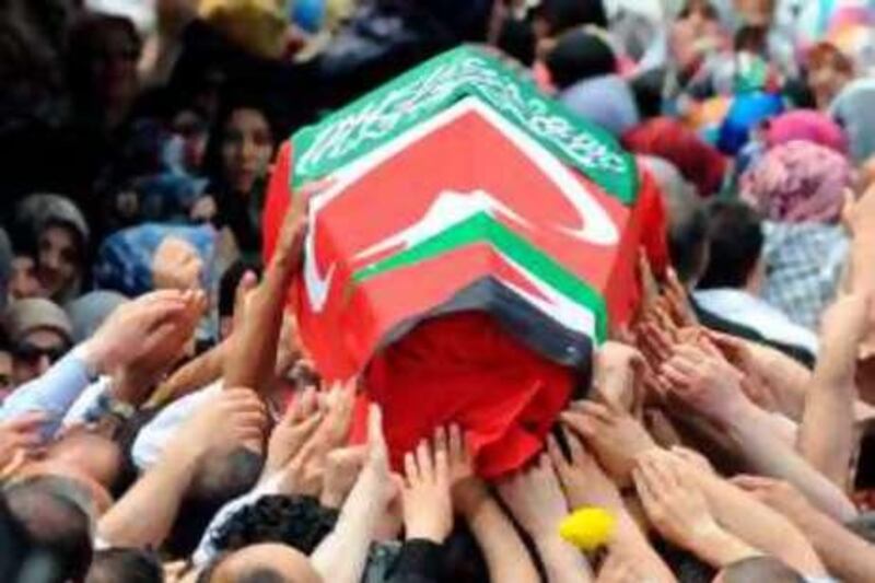 A coffin draped in a Turkish and a Palestinian flag is carried along during a funeral service to the victims of Israel's deadly raid on aid ships bound for Gaza at the Fatih Mosque in Istanbul on June 3, 2010. Nine people -- eight Turks and a US national of Turkish origin -- were killed in Monday's pre-dawn raid by Israeli forces on the Turkish ferry, Mavi Marmara, the lead ship in the aid flotilla aiming to break the crippling blockade of Gaza.<br />AFP PHOTO / MUSTAFA OZER *** Local Caption ***  674006-01-08.jpg