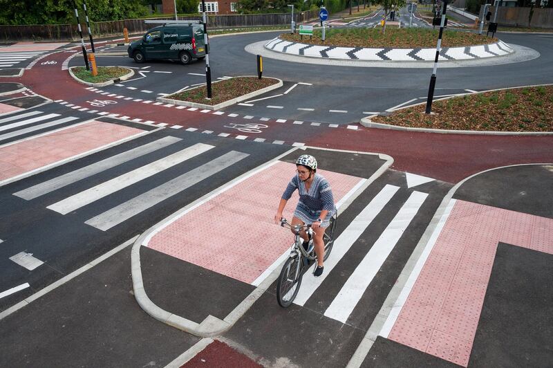 CAMBRIDGE, ENGLAND - AUGUST 10: A cyclist negotiates the new cycle-friendly roundabout on August 10, 2020 in Cambridge, England. The roundabout on Fendon Road was unveiled at the end of July and is the first of its kind in the UK. It provides an outer ring for cyclists and zebra crossings for pedestrians, requiring motorists to yield to both before entering. (Photo by Leon Neal/Getty Images)