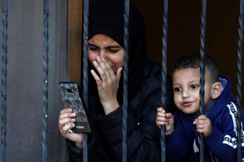 A relative of of Palestinian Yazan Abu Tabekh, who was killed during an Israeli raid, reacts as she looks through a window during his funeral in Jenin in the Israeli-occupied West Bank. Reuters