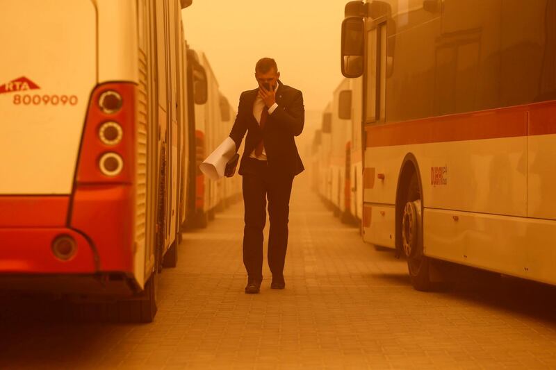 DUBAI, UNITED ARAB EMIRATES, 2 APRIL, 2015. A commuter walks through the Al Quoz bus stop while a sand storm rages around him. (Photo: Antonie Robertson) Journalist: Standalone. Section: Arts & Life. *** Local Caption ***  AR_0204_Sandstorm-05.JPG