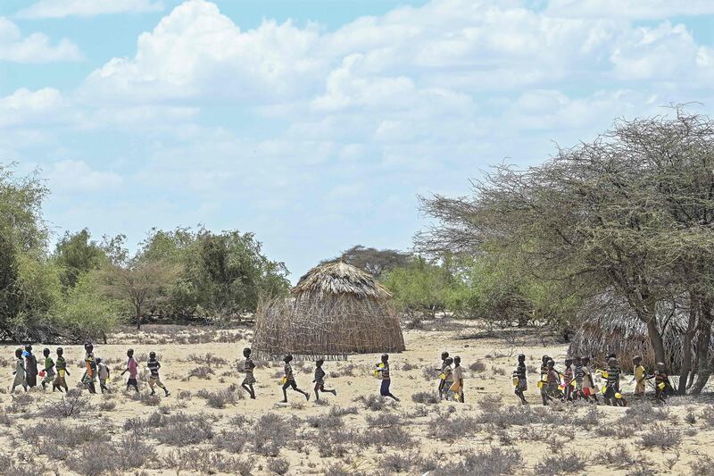 Children from the pastoral Turkana community on their way to a food aid distribution point during a drought-intervention community outreach clinic organised by Unicef at Nadoto village. The Horn of Africa is facing its worst drought in more than four decades with more than 20 million people, including 10 million children, in Djibouti, Ethiopia, Kenya and Somalia in need of water and food assistance. AFP