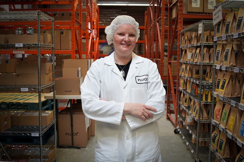 Ms Commins stands in her factory, where orders wait to be sent. Joshua Longmore / The National