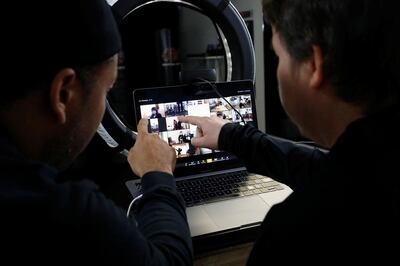 K’waun Conquest (L) and Parris Bender organize students before a live virtual lesson over Zoom at One Martial Arts as California continues its statewide "stay at home order" directing the state’s 40 million residents to stay in their homes in the face of the fast-spreading coronavirus disease (COVID-19) in Millbrae, California, U.S. March 23, 2020. REUTERS/Stephen Lam