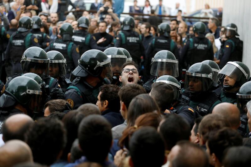 Scuffles break out as Spanish Civil Guard officers force their way through a crowd and into a polling station for the banned independence referendum in Spain. Juan Medina / Reuters