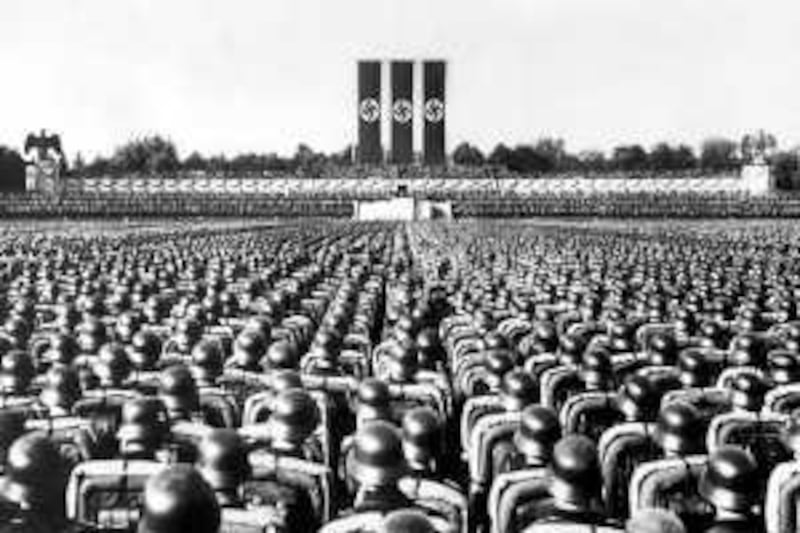 1936, Nuremberg, Germany --- A huge crowd of soldiers in combat gear stands at attention beneath the reviewing stand at Nuremberg, Germany, listening to a speech by the German Fuhrer, Adolf Hitler during the Nazi Party rally of 1936.  The Party held a similar rally here every year between 1933 and 1938. --- Image by © Bettmann/CORBIS
