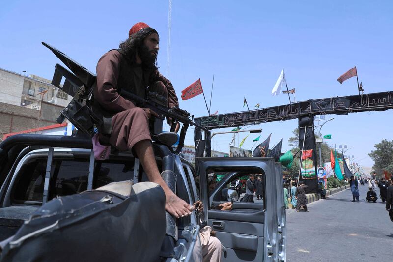 A Taliban fighter sitting on a vehicle guards the route of an Ashura procession in western city Herat. AFP