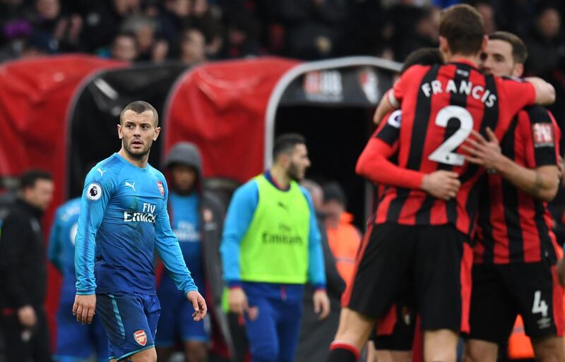 Soccer Football - Premier League - AFC Bournemouth vs Arsenal - Vitality Stadium, Bournemouth, Britain - January 14, 2018   Arsenal's Jack Wilshere looks dejected after the match as Bournemouth celebrate   REUTERS/Dylan Martinez    EDITORIAL USE ONLY. No use with unauthorized audio, video, data, fixture lists, club/league logos or "live" services. Online in-match use limited to 75 images, no video emulation. No use in betting, games or single club/league/player publications.  Please contact your account representative for further details.