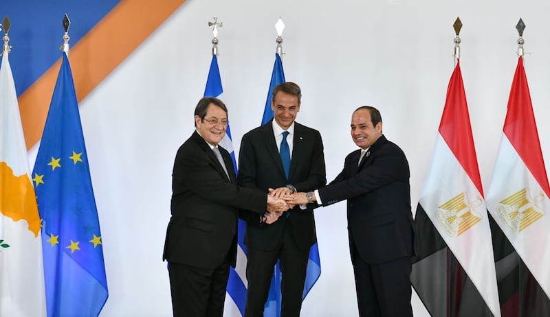 From right, Egyptian President Abdel Fattah El Sisi, Greek Prime Minister Kyriakos Mistsotakis and Cypriot President Nicos Anastasiades join hands during meeting in Athens on Tuesday. Photo: Egyptian Presidency