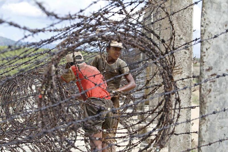 Workers set the barbed wire from Myanmar side at the Myanmar Bangladesh border fence in Maungdaw, Rakhine State, western Myanmar. Nyunt Win / EPA