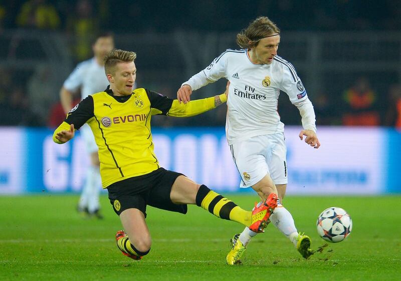 Marco Reus of Borussia Dortmund tackles Luka Modric of Real Madrid during their Uefa Champions League quarter-final second leg at Signal Iduna Park on April 8, 2014, in Dortmund, Germany.  Dennis Grombkowski / Getty Images