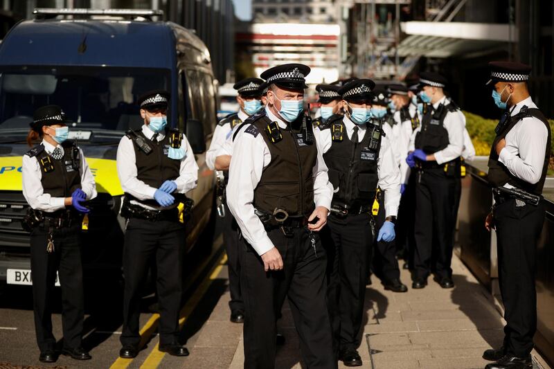 Police officers gather outside HSBC headquarters in Canary Wharf. Reuters