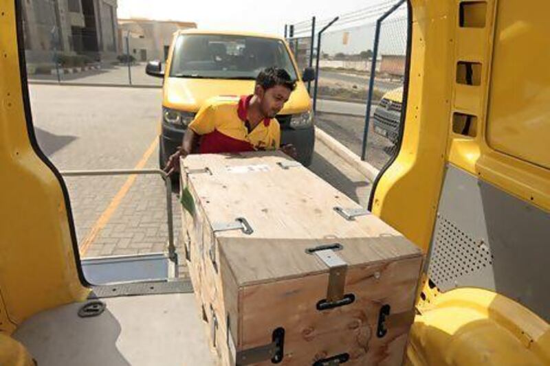 Jasim Muhammad, shown at the DHL warehouse in Dubai's Jebel Ali Free Zone, was the company's courier of the year for the UAE in 2012. Jeffrey E Biteng / The National