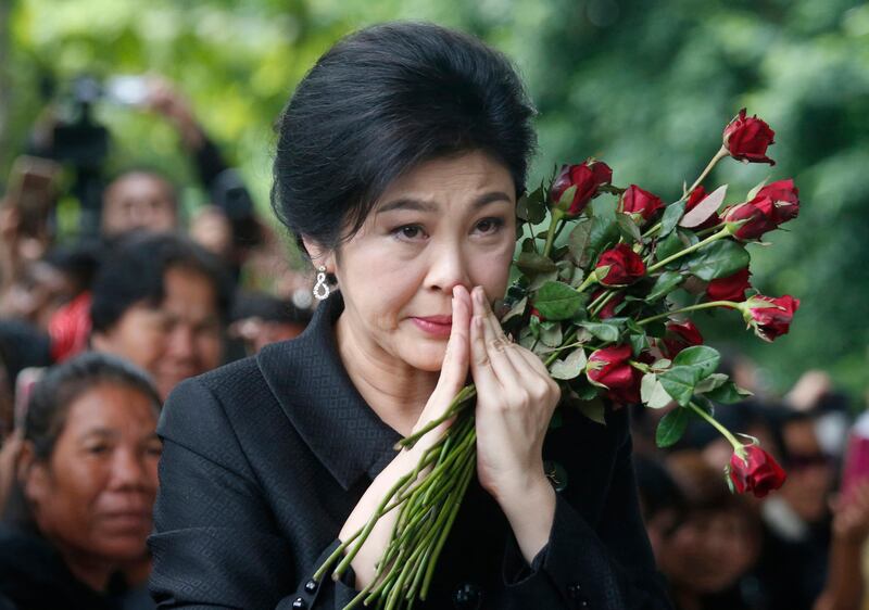 In this Friday, July 21, 2017, file photo, former Thailand's Prime Minister Yingluck Shinawatra arrives at the Supreme Court for the last day of her hearing in Bangkok Thailand, Bangkok, Thailand. Facing a possible 10-year jail term, the former prime minister fled the country ahead of a court verdict her supporters say was politically motivated, a senior member of her party said. (AP Photo Sakchai Lalit, File)
