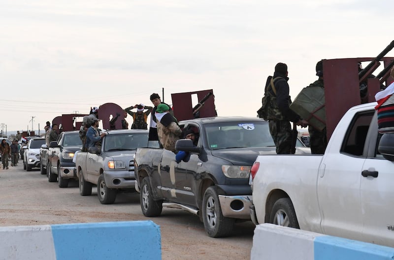 A convoy of pro-Syrian government fighters arriving in Syria's northern region of Afrin. George Ourfalian / AFP