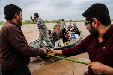 Soldiers help civilians in a flooded area near the city of Ahvaz in Iran's Khuzestan province on March 31, 2019. AFP