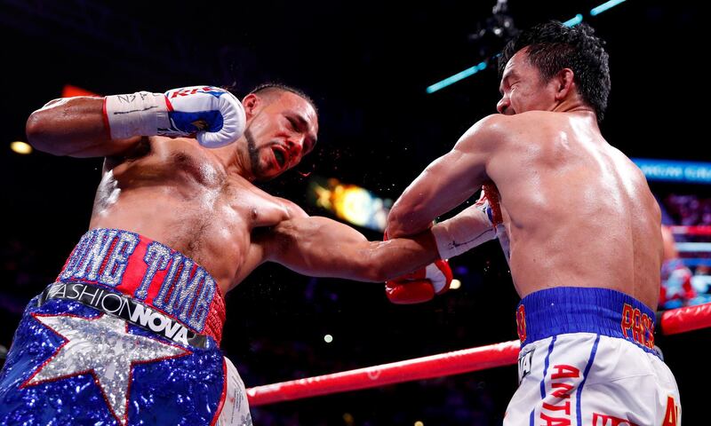 Manny Pacquiao, right, and Keith Thurman exchange punches in the fifth round. AP Photo