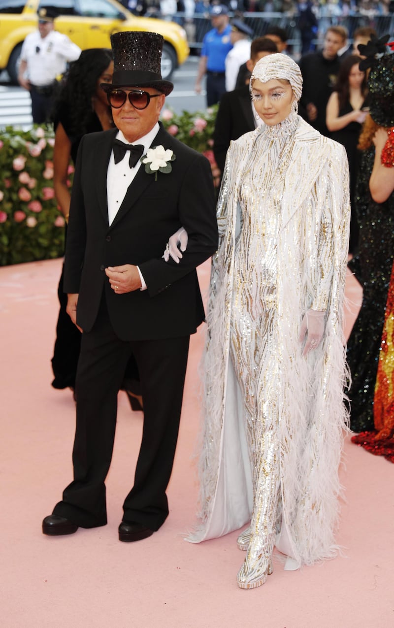 While Gigi Hadid looked ethereal in silvery white, it was designer Michael Kors in a flared tuxedo and top hat that stole the show. EPA